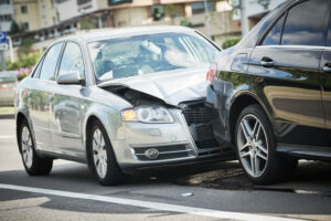 Damaged cars from rear-end collision along the road
